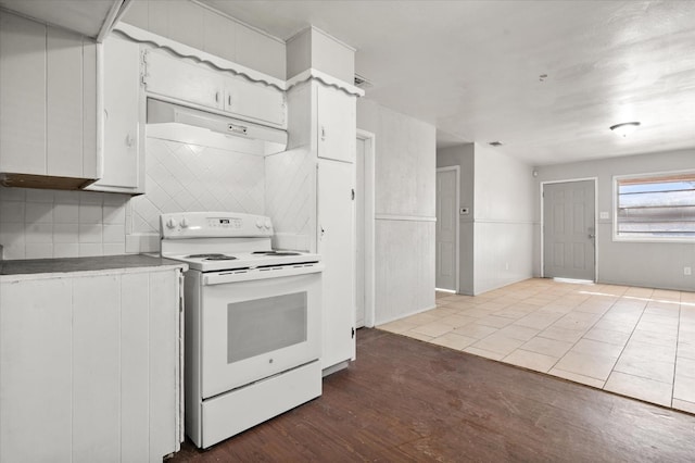 kitchen with white cabinetry, white range with electric cooktop, and wood-type flooring