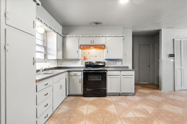 kitchen with sink, light tile patterned floors, white cabinets, and black range with electric cooktop