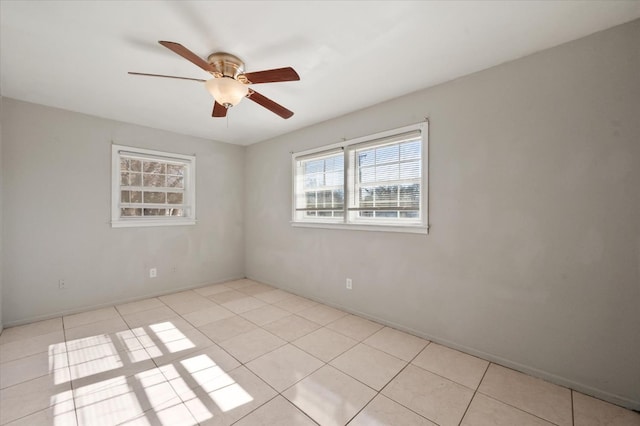 tiled spare room with ceiling fan