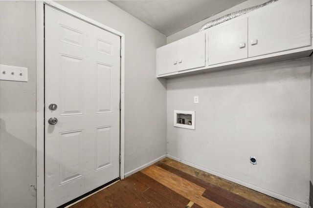 clothes washing area featuring electric dryer hookup, hookup for a washing machine, dark hardwood / wood-style floors, and cabinets