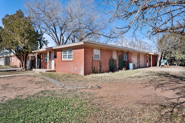 ranch-style house with central air condition unit