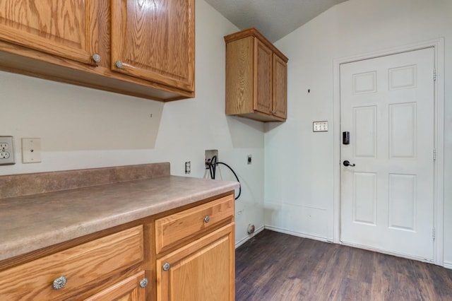 laundry area featuring electric dryer hookup, washer hookup, dark hardwood / wood-style floors, and cabinets