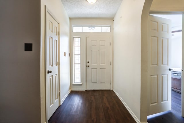 entrance foyer featuring dark wood-type flooring and a textured ceiling