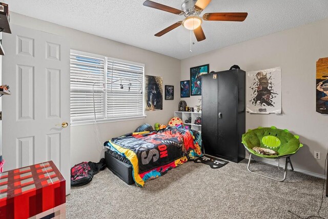 bedroom featuring a textured ceiling, carpet floors, and ceiling fan