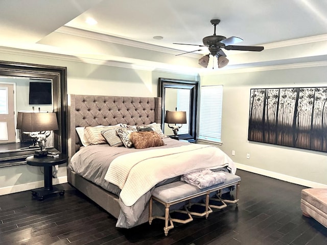 bedroom with crown molding, ceiling fan, dark hardwood / wood-style flooring, and a raised ceiling