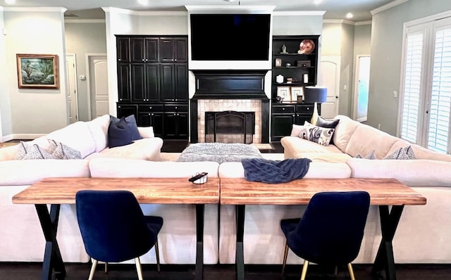 living room featuring crown molding and a tile fireplace