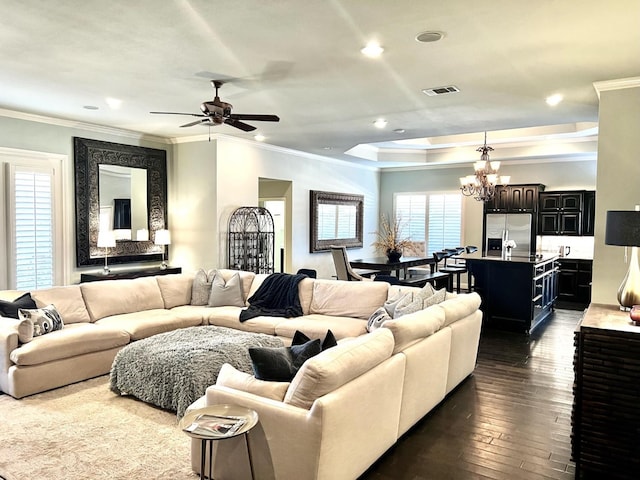 living room featuring dark hardwood / wood-style flooring, crown molding, and ceiling fan with notable chandelier