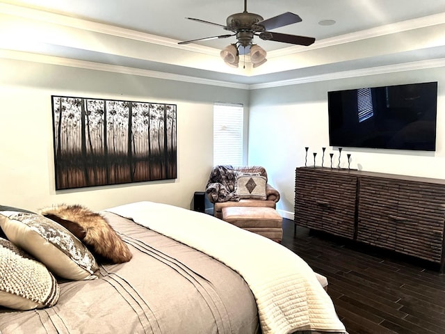 bedroom with a raised ceiling, ornamental molding, ceiling fan, and dark hardwood / wood-style flooring