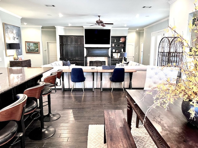 interior space with ornamental molding, dark hardwood / wood-style floors, and ceiling fan