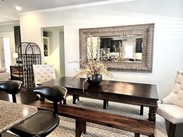 dining area featuring crown molding, wood-type flooring, and a wealth of natural light