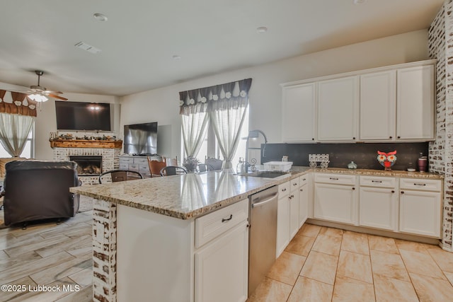 14320 Ave U, Lubbock, TX 79423 - kitchen with dishwasher, plenty of natural light, a brick fireplace, and ceiling fan