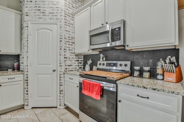14320 Ave U, Lubbock, TX 79423 - kitchen featuring stainless steel appliances, tasteful backsplash, and white cabinets
