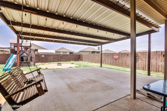 14320 Ave U, Lubbock, TX 79423 - fenced backyard with a patio area and a playground