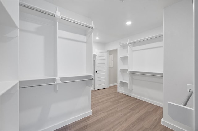 walk in closet with light wood-type flooring