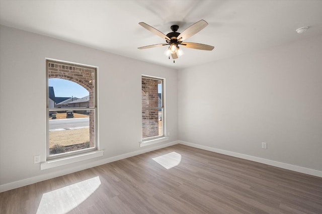 unfurnished room with hardwood / wood-style floors and ceiling fan