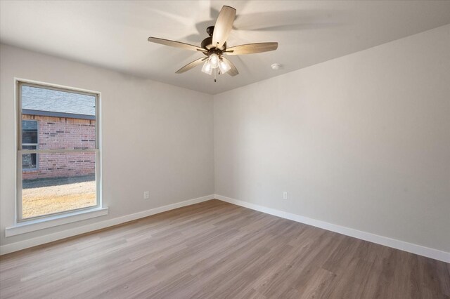 unfurnished room with a wealth of natural light, light hardwood / wood-style flooring, and ceiling fan