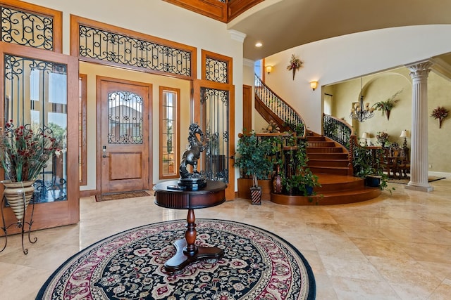 entryway with a high ceiling and ornate columns