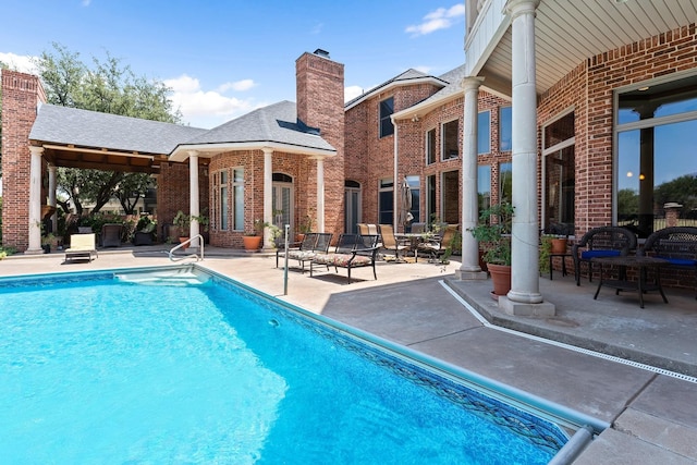 view of pool featuring a patio