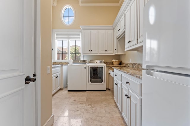 laundry area featuring cabinets, washing machine and dryer, and ornamental molding