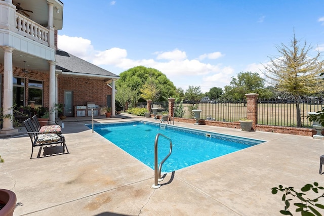 view of pool featuring ceiling fan and a patio