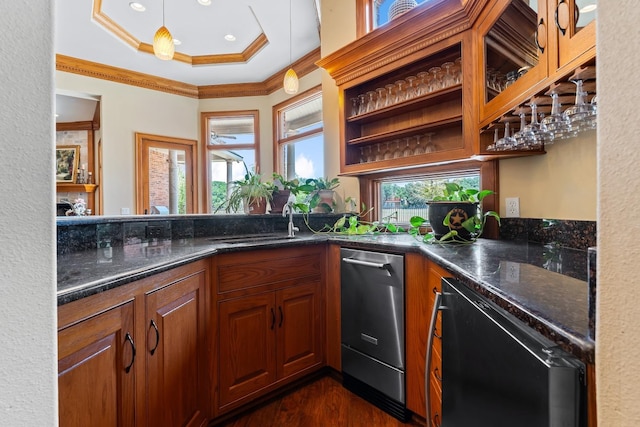 kitchen featuring pendant lighting, black dishwasher, dark stone countertops, dark hardwood / wood-style flooring, and ornamental molding