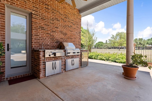 view of patio with area for grilling and ceiling fan