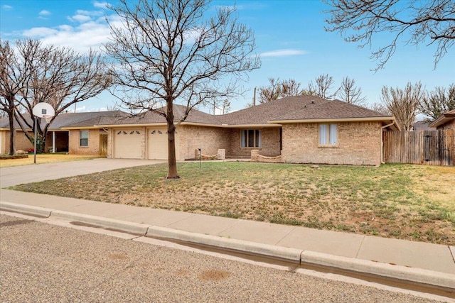 ranch-style home with concrete driveway, a garage, a front lawn, and fence