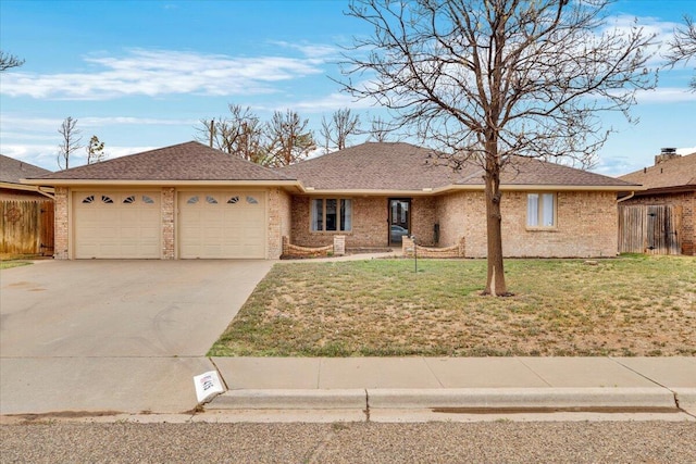 ranch-style home with a front lawn, a garage, driveway, brick siding, and fence