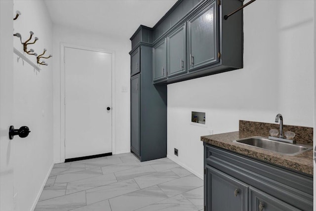 laundry room with cabinet space, a sink, washer hookup, and baseboards