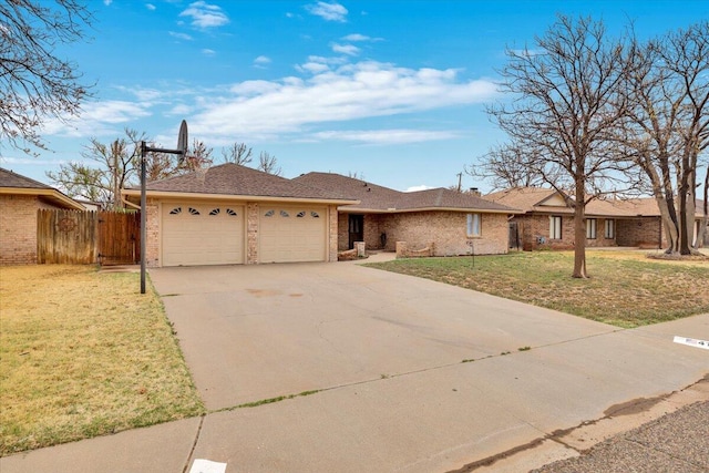 ranch-style house featuring brick siding, fence, driveway, a front yard, and an attached garage