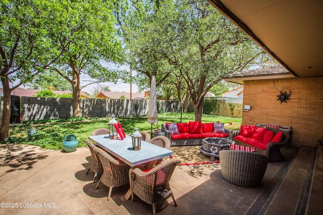 610 N 20th St, Lamesa, TX 79331 - fenced backyard featuring an outdoor living space with a fire pit and a patio area