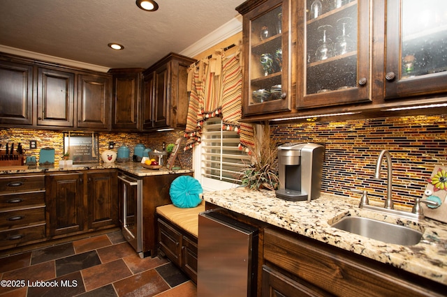 610 N 20th St, Lamesa, TX 79331 - kitchen featuring wine cooler, dark brown cabinets, recessed lighting, and crown molding