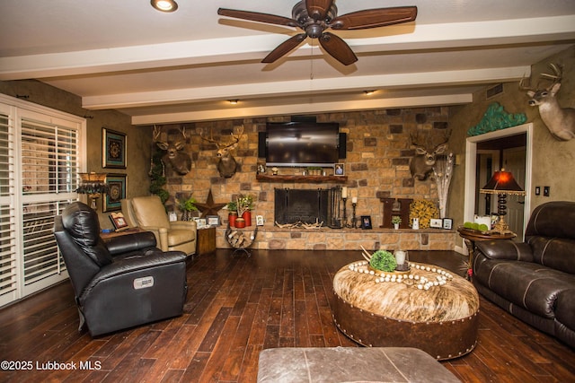 610 N 20th St, Lamesa, TX 79331 - living room featuring a fireplace, beamed ceiling, ceiling fan, and hardwood / wood-style floors