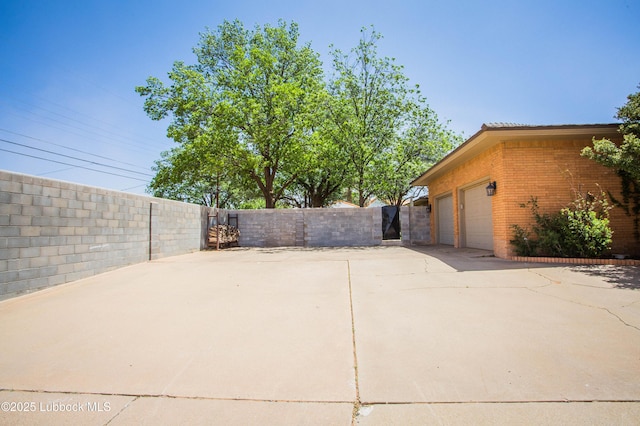 610 N 20th St, Lamesa, TX 79331 - view of patio / terrace with a gate and an attached garage