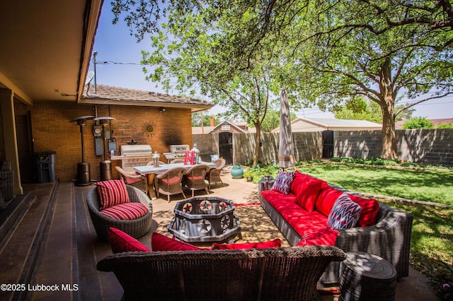 610 N 20th St, Lamesa, TX 79331 - fenced backyard featuring an outdoor living space, outdoor dining area, a grill, and a patio