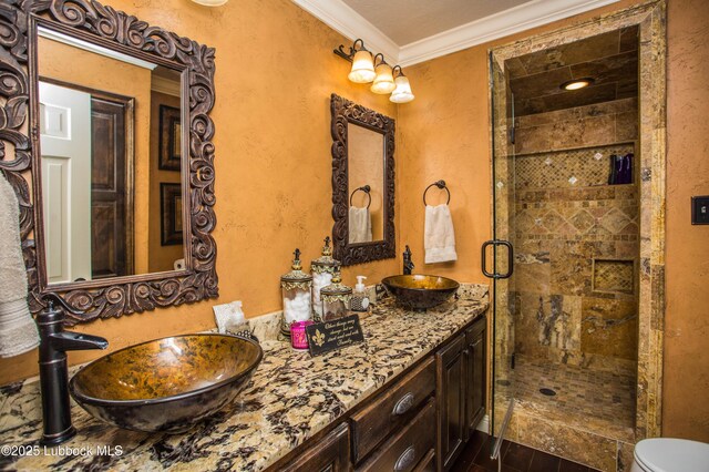 610 N 20th St, Lamesa, TX 79331 - full bath featuring double vanity, a shower stall, ornamental molding, and a textured wall