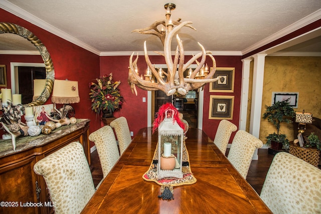 610 N 20th St, Lamesa, TX 79331 - dining area featuring a chandelier, wood finished floors, crown molding, and decorative columns