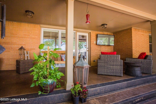 610 N 20th St, Lamesa, TX 79331 - view of exterior entry featuring brick siding and a porch
