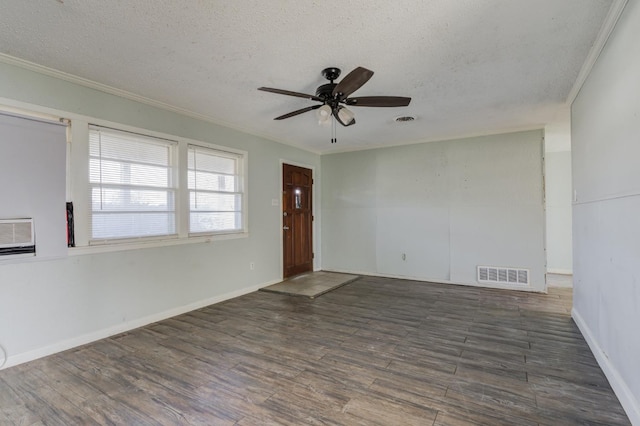 spare room featuring crown molding, ceiling fan, dark hardwood / wood-style floors, and a textured ceiling