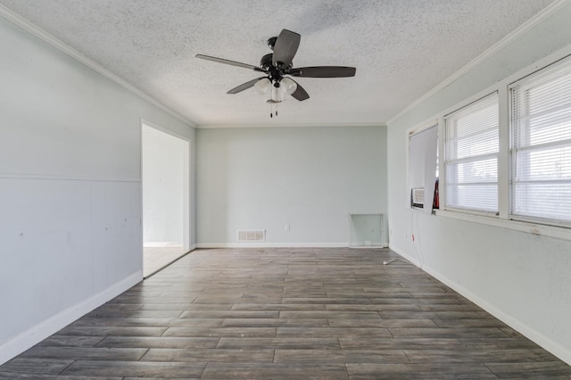 empty room featuring ornamental molding, dark wood-type flooring, ceiling fan, and a textured ceiling