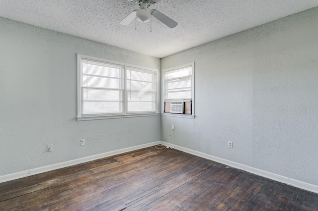 spare room featuring ceiling fan, cooling unit, a textured ceiling, and dark hardwood / wood-style flooring