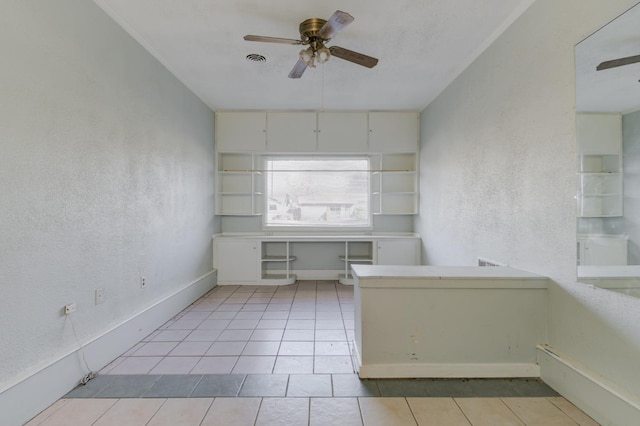 unfurnished office with light tile patterned floors and ceiling fan