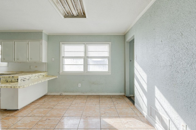 kitchen featuring light tile patterned floors and ornamental molding