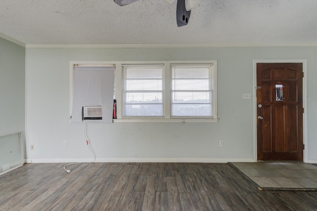 spare room with ornamental molding, dark hardwood / wood-style floors, and a textured ceiling