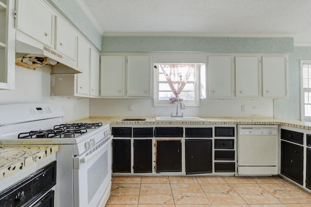 kitchen featuring ornamental molding, sink, white cabinets, and white appliances