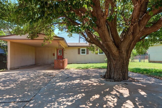 view of front of house with a front lawn and a carport