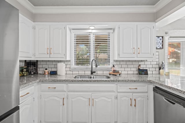 kitchen with appliances with stainless steel finishes, sink, and white cabinets