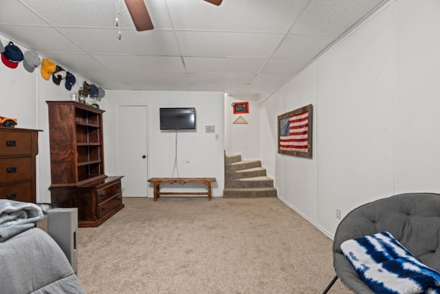 interior space with light carpet, a paneled ceiling, and ceiling fan