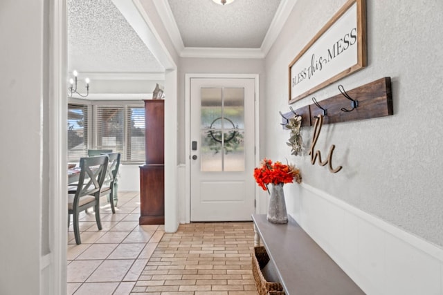 mudroom with ornamental molding, an inviting chandelier, and a textured ceiling