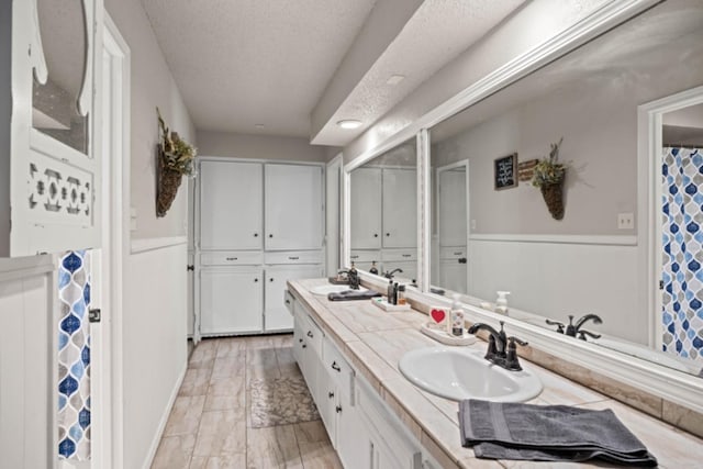 bathroom featuring vanity and a textured ceiling